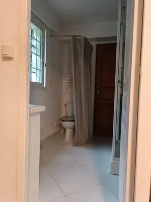 a bedroom with two beds and a mirror at Studio Dauphiné in Nice