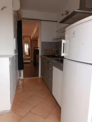 a kitchen with wooden cabinets and a microwave at Studio Dauphiné in Nice