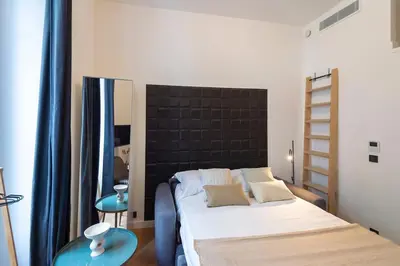 a bedroom with a bed and two blue tables at Charmant appartement rénové au cœur de Nice in Nice