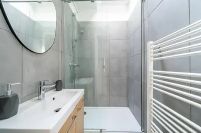 a bathroom with a shower and a sink and a mirror at Studio hypercentre de Nice climatisé in Nice