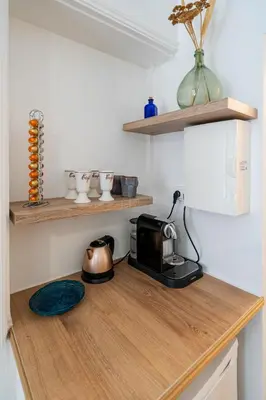 a microwave on a wooden counter in a kitchen at Studio hypercentre de Nice climatisé in Nice