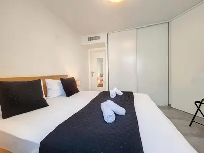 a bedroom with a bed with two white towels on it at Nestor&Jeeves - FRESCO - Central - Very close sea - Balcony in Nice