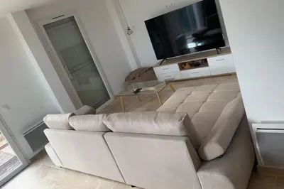a bedroom with a bed and a television and a window at Maison Clémentine in Cros-de-Cagnes