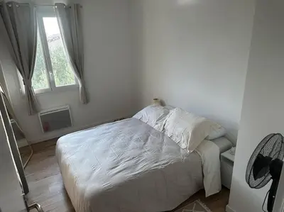 a white couch in a living room with a table at Maison Clémentine in Cros-de-Cagnes