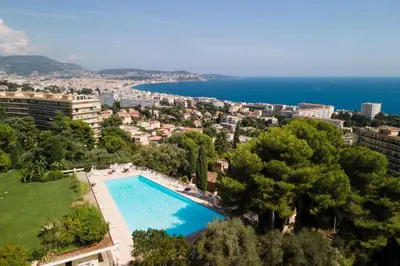 an aerial view of a swimming pool with a city and the ocean at Nice Renting - ABBAYE - Luxury Penthouse Sea View Pool Tennis Parking in Nice