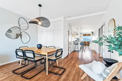 a dining room and living room with a table and chairs at Nice Renting - ABBAYE - Luxury Penthouse Sea View Pool Tennis Parking in Nice