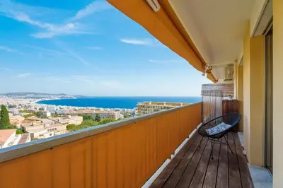 a balcony with a bench and a view of the ocean at Nice Renting - ABBAYE - Luxury Penthouse Sea View Pool Tennis Parking in Nice