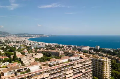 an aerial view of a city and the ocean at Nice Renting - ABBAYE - Luxury Penthouse Sea View Pool Tennis Parking in Nice