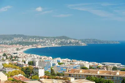 a view of a city with a body of water at Nice Renting - ABBAYE - Luxury Penthouse Sea View Pool Tennis Parking in Nice