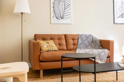 a living room with a brown couch and a table at Shopping et Détente au Centre Ville de Nice ! in Nice