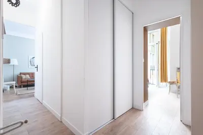 a hallway with white walls and an open door at Shopping et Détente au Centre Ville de Nice ! in Nice