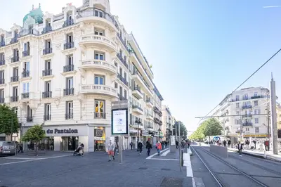 a city street with a large white building at Shopping et Détente au Centre Ville de Nice ! in Nice