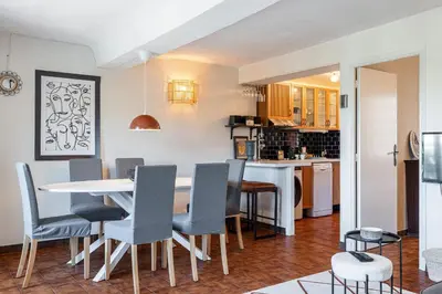 a kitchen and dining room with a table and chairs at 2 Bdr Panoramic View on Gardens in Nice