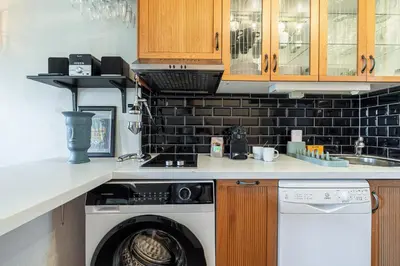 a kitchen with a washing machine and a sink at 2 Bdr Panoramic View on Gardens in Nice