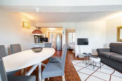 a living room and dining room with a table and chairs at 2 Bdr Panoramic View on Gardens in Nice