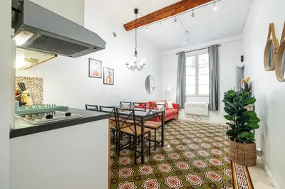 a kitchen and a living room with a table at 2 Bdr with Independent Studio - Old Town in Nice