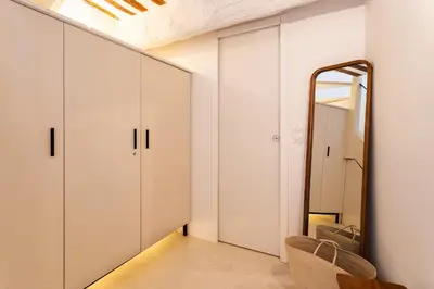 a dressing room with white cabinets and a mirror at LA CASETTA DI AZZURRA AP4427 By Riviera Holiday Homes in Villefranche-sur-Mer
