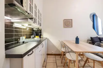 a kitchen with a wooden table and a counter top at 2 Bdr Heart Old Town Nice in Nice