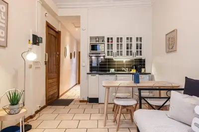 a living room with a table and a kitchen at 2 Bdr Heart Old Town Nice in Nice