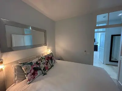 a bedroom with a bed with a mirror above it at Rossetti Rosa Vieux Nice 2 bed in Nice