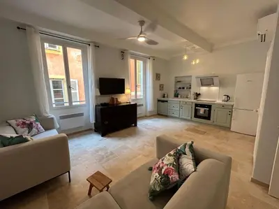a living room with two couches and a kitchen at Rossetti Rosa Vieux Nice 2 bed in Nice