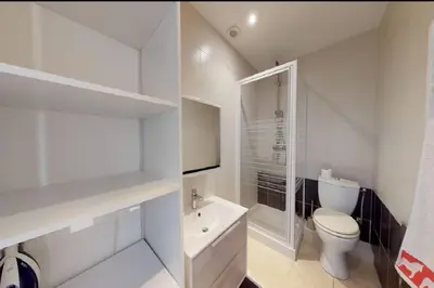 a white bathroom with a toilet and a sink at Appt 2 pièces 43 Avenue Jean Médecin in Nice
