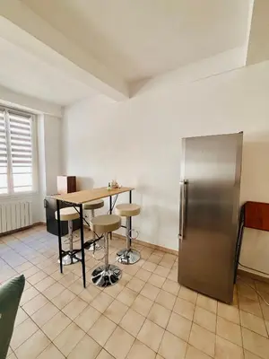 a kitchen with a table and a refrigerator at Heart of the Old City - Nice in Nice