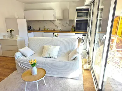 a living room with a white couch and a table at Superbe Appartement Luxueux Spacieux 50 m2 Port Nice in Nice