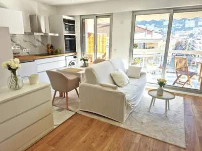 a kitchen and living room with a couch and a table at Superbe Appartement Luxueux Spacieux 50 m2 Port Nice in Nice