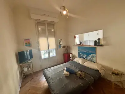 a bedroom with a large bed and a window at Appartement Nice centre ville gare in Nice