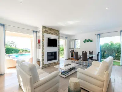 a living room with white furniture and a fireplace at CASA-Mathilda luxueuse villa moderne avec piscine in La Gaude
