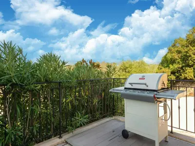 a grill on a balcony with a fence at CASA-Mathilda luxueuse villa moderne avec piscine in La Gaude