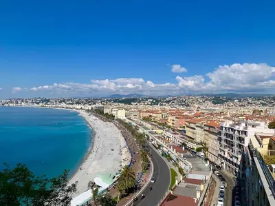 a view of a city with a beach and the ocean at La Vague Bleue in Nice