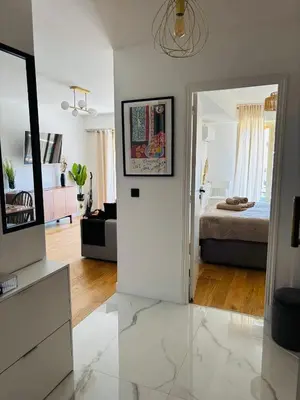 a living room with a room with a bed and a mirror at Residence Butterfly in Nice