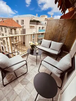 a balcony with couches and a table on a building at Residence Butterfly in Nice