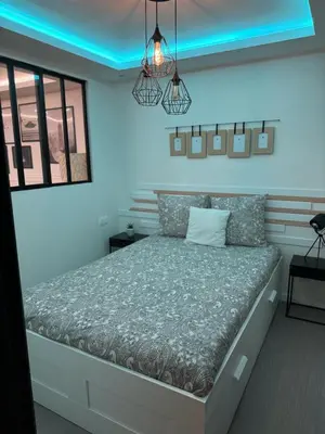 a bedroom with a large bed with blue lighting at APPARTEMENt COSY in Nice