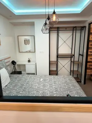a bedroom with a bed and a room with a ladder at APPARTEMENt COSY in Nice