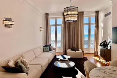 a living room with a couch and a table at QUAI PROMENADE VIEW Sea View Balcony 3 Bedrooms Air Conditioning in Nice