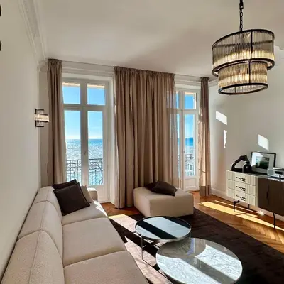 a living room with a couch and a table at QUAI PROMENADE VIEW Sea View Balcony 3 Bedrooms Air Conditioning in Nice