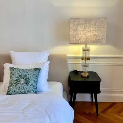 a bedroom with a bed and a nightstand with a lamp at QUAI PROMENADE VIEW Sea View Balcony 3 Bedrooms Air Conditioning in Nice