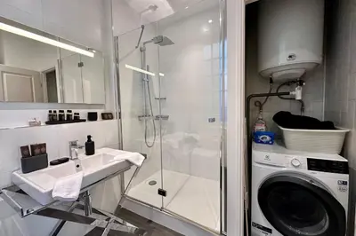 a bathroom with a sink and a washing machine at QUAI PROMENADE VIEW Sea View Balcony 3 Bedrooms Air Conditioning in Nice