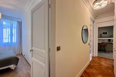 a bedroom with a bed and a mirror on a wall at QUAI PROMENADE VIEW Sea View Balcony 3 Bedrooms Air Conditioning in Nice