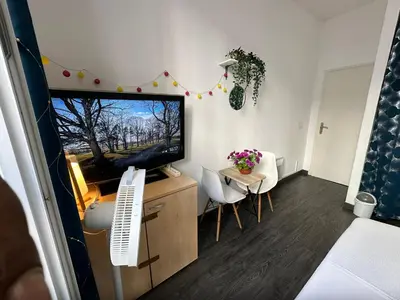 a small bedroom with a bed and a window at Delight room 1st door in Nice