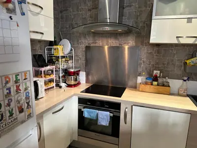 a kitchen with a counter with chairs in it at Delight room 1st door in Nice