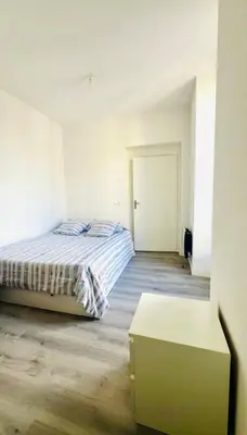 a bedroom with a bed and a table in it at Spacieux 4 couchage plein centre in Nice