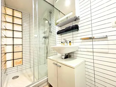 a white bathroom with a sink and a shower at Cosy appart 4pers vieux Nice in Nice