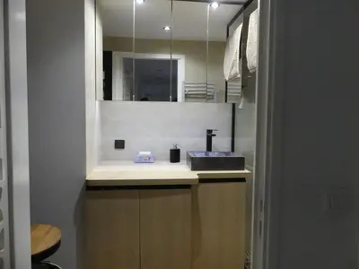a bathroom with a sink and a mirror at 68 m2 central pour des vacances en famille in Nice