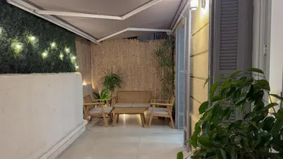 an outdoor patio with a table and chairs and lights at Central Studio - Bright & Modern - Private Terrace - AirCon - Near Train & Beach in Nice
