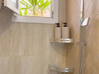 a bathroom with a shower and a sink with a window at Central Studio - Bright & Modern - Private Terrace - AirCon - Near Train & Beach in Nice