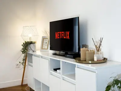 a living room with a tv on a white entertainment center at Central Studio - Bright & Modern - Private Terrace - AirCon - Near Train & Beach in Nice